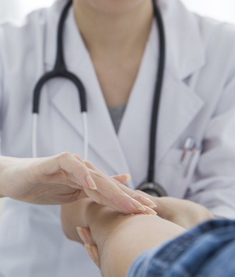 doctor rubbing cream on patient's arm